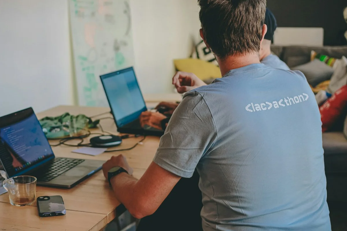 Illustrative people collaborating on laptops — not an ITIQ activity